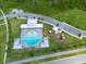Aerial view of community pool and playground, with ample parking and lush landscaping at 18424 Cypress Bay Pkwy, Land O Lakes, FL 34638