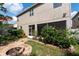 Charming backyard featuring a fire pit, meticulous landscaping, and privacy plants at 18424 Cypress Bay Pkwy, Land O Lakes, FL 34638
