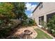 Landscaped backyard with inviting fire pit area and lush greenery, perfect for outdoor enjoyment at 18424 Cypress Bay Pkwy, Land O Lakes, FL 34638