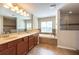 Well-lit bathroom featuring a double vanity, soaking tub, and a glass-enclosed shower at 18424 Cypress Bay Pkwy, Land O Lakes, FL 34638