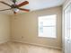 Neutral bedroom with a ceiling fan, bright window, and carpeting at 18424 Cypress Bay Pkwy, Land O Lakes, FL 34638