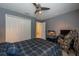 Bedroom with bed, double closet, reptile terrarium and desk at 18424 Cypress Bay Pkwy, Land O Lakes, FL 34638