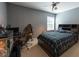 Bedroom with desk, reptile terrarium and bed with blue-and-black comforter at 18424 Cypress Bay Pkwy, Land O Lakes, FL 34638