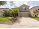 Charming two-story home featuring a well-maintained lawn and a two-car garage at 18424 Cypress Bay Pkwy, Land O Lakes, FL 34638