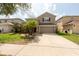 Charming two-story home featuring a well-maintained lawn and a two-car garage at 18424 Cypress Bay Pkwy, Land O Lakes, FL 34638