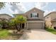 Beautiful two-story home with a well-manicured front yard and a spacious two-car garage at 18424 Cypress Bay Pkwy, Land O Lakes, FL 34638