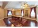 Bright game room with a pool table, ceiling fan, and elegant window treatments at 18424 Cypress Bay Pkwy, Land O Lakes, FL 34638