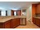Modern kitchen with granite countertops and stainless steel dishwasher at 18424 Cypress Bay Pkwy, Land O Lakes, FL 34638