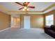 Open living room with bright walls, carpeting, ceiling fan and trim at 18424 Cypress Bay Pkwy, Land O Lakes, FL 34638