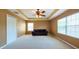 Open living area featuring bright natural light, neutral walls, and a ceiling fan at 18424 Cypress Bay Pkwy, Land O Lakes, FL 34638