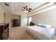 This large main bedroom features a tray ceiling and a tropical ceiling fan at 18424 Cypress Bay Pkwy, Land O Lakes, FL 34638