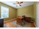 Home office featuring a wood desk, ceiling fan, and natural light at 18424 Cypress Bay Pkwy, Land O Lakes, FL 34638
