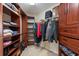 Organized walk-in closet with custom shelves, hanging racks, and drawers for optimal storage at 18424 Cypress Bay Pkwy, Land O Lakes, FL 34638