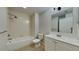 Well-lit bathroom features a tub, shower, and a vanity at 1850 Fuller Dr, Clearwater, FL 33755