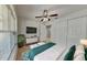 Cozy bedroom with a ceiling fan, white closet doors, and a large window for ample natural light at 1850 Fuller Dr, Clearwater, FL 33755