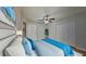 Inviting bedroom featuring a comfortable bed, ceiling fan, closet, and neutral decor for a serene ambiance at 1850 Fuller Dr, Clearwater, FL 33755