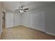 Bedroom with tile floors, large closet, and a ceiling fan at 1850 Fuller Dr, Clearwater, FL 33755