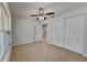 Spacious bedroom featuring tile floors, a ceiling fan, and a large closet at 1850 Fuller Dr, Clearwater, FL 33755