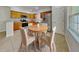 Bright kitchen featuring stainless steel appliances, light wood cabinetry, and an adjacent dining area with seating at 1850 Fuller Dr, Clearwater, FL 33755