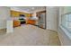 Modern kitchen with stainless steel appliances, wooden cabinetry, granite countertops, and ample natural light at 1850 Fuller Dr, Clearwater, FL 33755