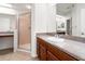 Bathroom featuring a walk-in shower, vanity and mirror with beautiful granite countertops at 1936 Heron Cove Dr # 104, Lutz, FL 33549