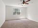 Bedroom with a ceiling fan and a window that provides a view of the outside at 1936 Heron Cove Dr # 104, Lutz, FL 33549