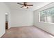 Bedroom with a ceiling fan and a window that provides a view of the outside at 1936 Heron Cove Dr # 104, Lutz, FL 33549