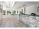 Bright and airy clubhouse featuring an open floor plan, tile floors, and a stone-accented bar area at 1936 Heron Cove Dr # 104, Lutz, FL 33549