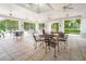 Spacious clubhouse with ample seating, tile floors, and large windows offering scenic outdoor views at 1936 Heron Cove Dr # 104, Lutz, FL 33549