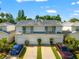 Shot of a residential condo, two-story, in a row, with attached garages at 1936 Heron Cove Dr # 104, Lutz, FL 33549