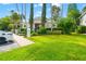 Charming building exterior with lush landscaping, well-maintained lawn, and convenient parking at 1936 Heron Cove Dr # 104, Lutz, FL 33549