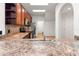 Functional kitchen featuring wooden cabinetry, stainless steel appliances, and a view of the entryway at 1936 Heron Cove Dr # 104, Lutz, FL 33549