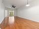 Bright living room with hardwood floors, ceiling fan, and sliding glass doors at 1936 Heron Cove Dr # 104, Lutz, FL 33549