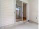 Back patio with sliding glass doors leading to an enclosed porch at 1936 Heron Cove Dr # 104, Lutz, FL 33549