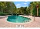 Resort-style pool with a clear blue water, poolside landscaping, and brick-paved deck for relaxation at 1936 Heron Cove Dr # 104, Lutz, FL 33549