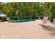 Inviting community pool area surrounded by lush landscaping and comfortable lounge chairs at 1936 Heron Cove Dr # 104, Lutz, FL 33549
