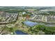 Scenic aerial view of the property situated by a peaceful lake and surrounded by a well-connected network of roads at 21642 Emory Oak Pl, Land O Lakes, FL 34637