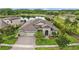 Stunning aerial view of home showcases a three-car garage, lush landscaping, and inviting entrance at 21642 Emory Oak Pl, Land O Lakes, FL 34637