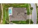 Overhead view of a home featuring a pristine pool, and meticulously maintained landscaping at 21642 Emory Oak Pl, Land O Lakes, FL 34637