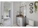 Powder room with decorative mirrors, granite countertop, and access to the outdoor space at 21642 Emory Oak Pl, Land O Lakes, FL 34637