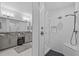 Luxurious bathroom showcasing a double vanity, walk-in shower with textured tile, and upscale finishes at 21642 Emory Oak Pl, Land O Lakes, FL 34637