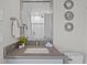 Bathroom featuring granite countertop, decorative mirror, and access to the shower room at 21642 Emory Oak Pl, Land O Lakes, FL 34637