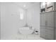 Bright bathroom with a modern tub, textured tile, built-in shelving, and marble floors creates a spa-like feel at 21642 Emory Oak Pl, Land O Lakes, FL 34637