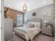 Bedroom featuring a brick wall accent, neutral decor, and comfortable bed at 21642 Emory Oak Pl, Land O Lakes, FL 34637