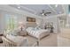 Inviting bedroom with tray ceiling, large windows and stylish furnishings at 21642 Emory Oak Pl, Land O Lakes, FL 34637