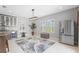Sun-filled dining area with modern light fixture, bar area, and stainless-steel refrigerator at 21642 Emory Oak Pl, Land O Lakes, FL 34637