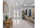 Inviting foyer with decorative lighting, tile floors, and views to the living area at 21642 Emory Oak Pl, Land O Lakes, FL 34637