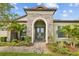 Beautiful front entrance with stone accents and lush landscaping at 21642 Emory Oak Pl, Land O Lakes, FL 34637