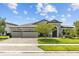 Charming single-story home features a 3-car garage and a beautifully landscaped front yard at 21642 Emory Oak Pl, Land O Lakes, FL 34637