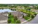 Charming home showcasing manicured landscaping, a well-maintained lawn, and a welcoming entryway near a serene lake at 21642 Emory Oak Pl, Land O Lakes, FL 34637